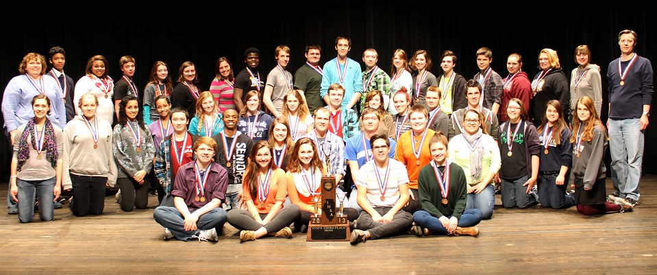 Cast and crew with trophy